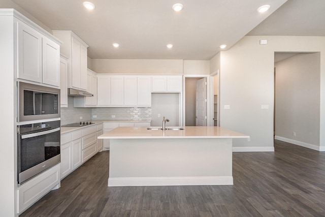 kitchen featuring tasteful backsplash, sink, black appliances, a center island with sink, and white cabinetry