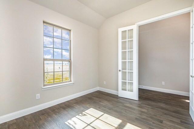 spare room featuring french doors, dark hardwood / wood-style floors, and lofted ceiling