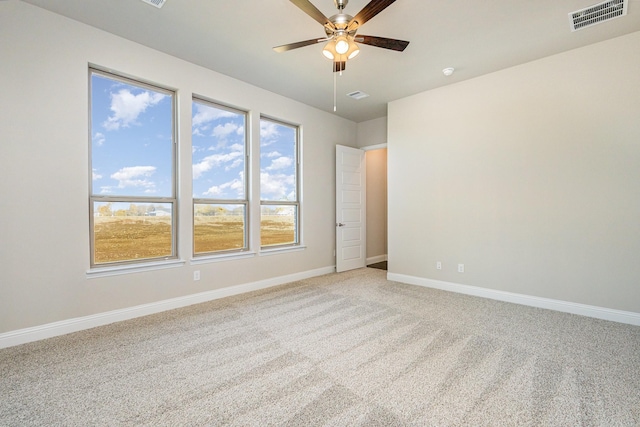 carpeted spare room with ceiling fan