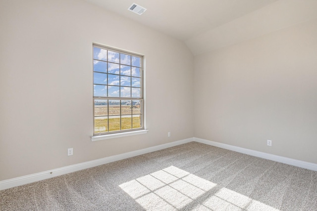 unfurnished room featuring carpet and vaulted ceiling