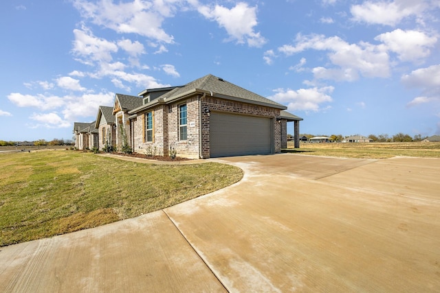 view of side of home featuring a yard and a garage