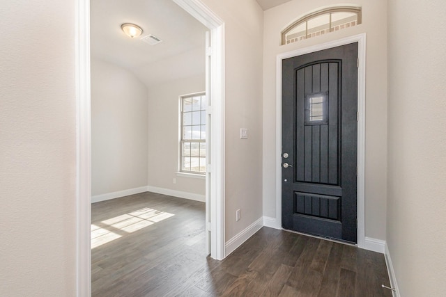 foyer featuring vaulted ceiling and dark wood-type flooring