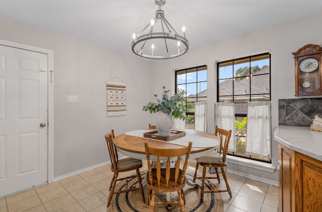 tiled dining space featuring a healthy amount of sunlight and a chandelier