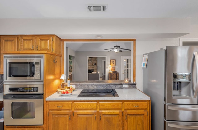 kitchen with ceiling fan and stainless steel appliances