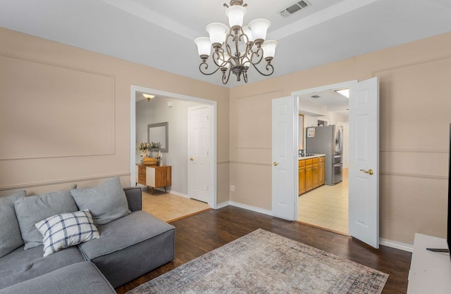 living room featuring dark hardwood / wood-style flooring and a chandelier