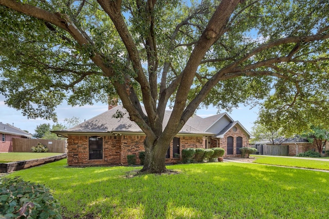 ranch-style home with a front lawn