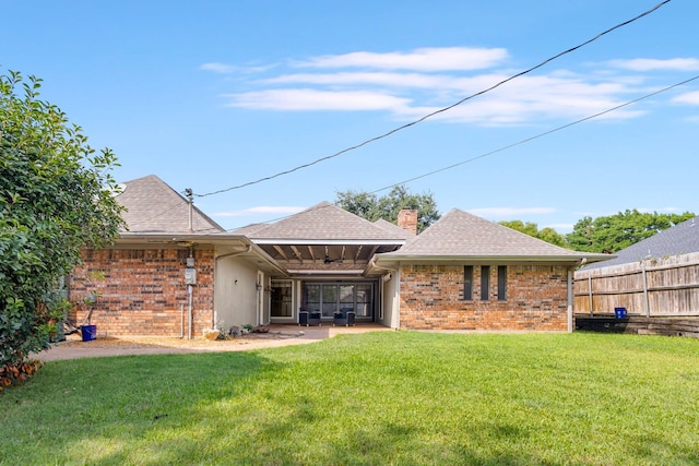 rear view of property featuring a yard