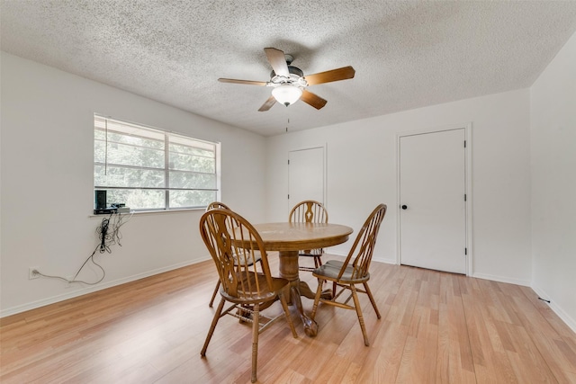 dining space featuring ceiling fan, a textured ceiling, and light hardwood / wood-style flooring