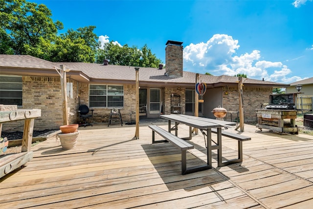 wooden deck featuring an outdoor fireplace