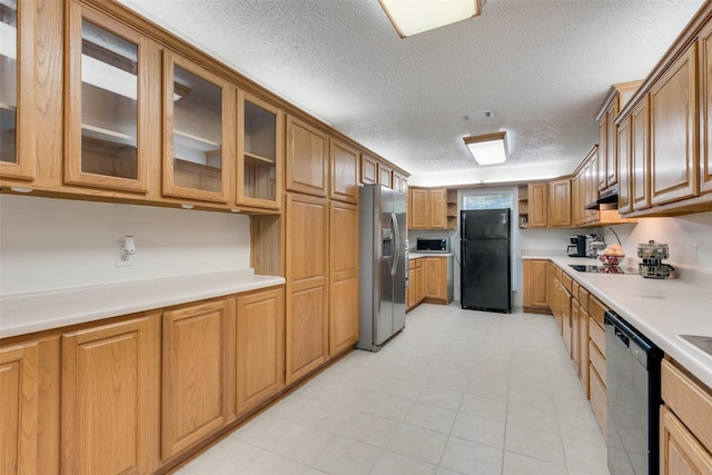 kitchen featuring a textured ceiling and stainless steel appliances