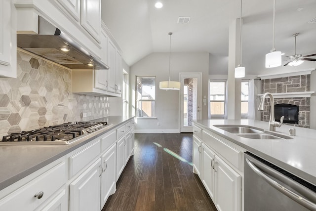 kitchen featuring stainless steel appliances, white cabinetry, tasteful backsplash, and sink