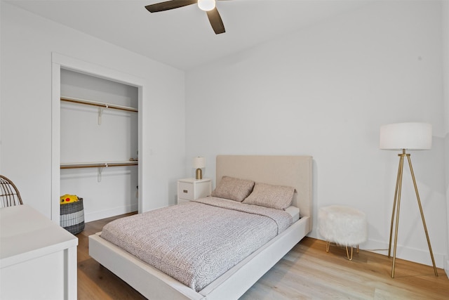 bedroom featuring ceiling fan, a closet, and wood-type flooring