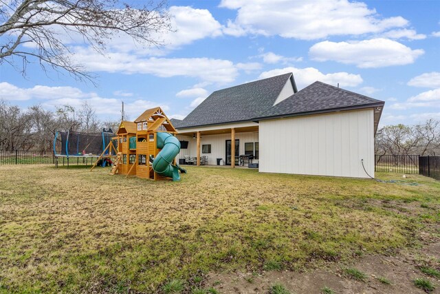 view of playground with a yard and a trampoline