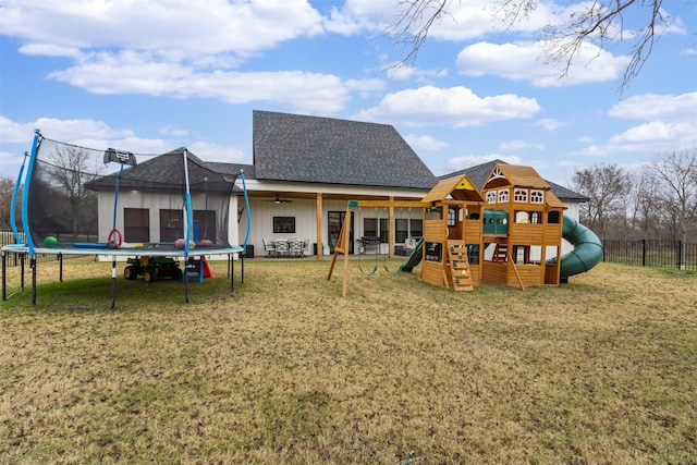 view of play area with a yard and a trampoline