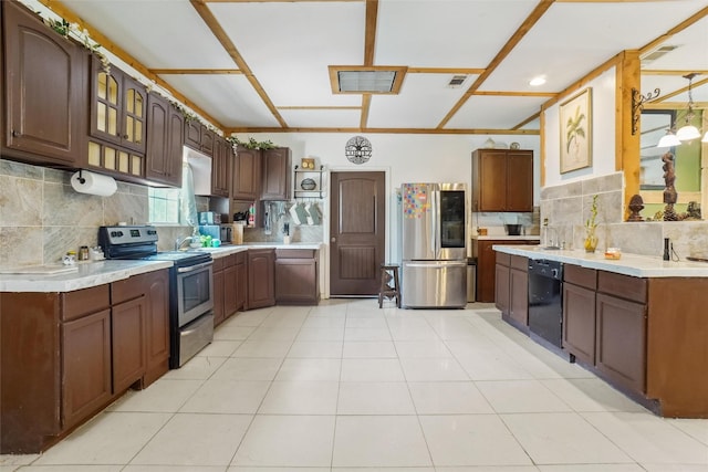 kitchen featuring dark brown cabinets, light tile patterned floors, stainless steel appliances, and tasteful backsplash