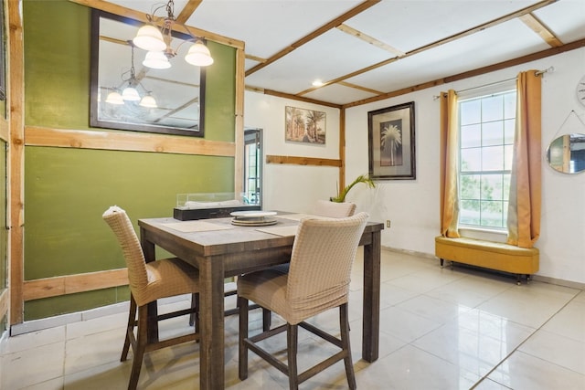 tiled dining room with an inviting chandelier