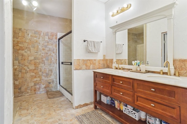 bathroom featuring vanity, tile walls, and a shower with shower door