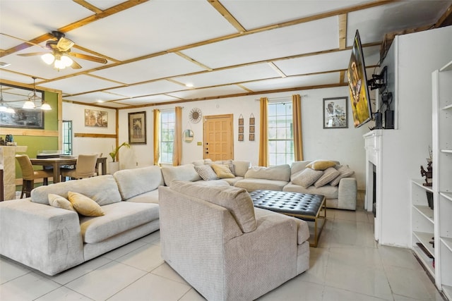 living room with ceiling fan and a healthy amount of sunlight