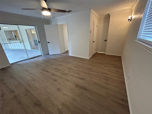 unfurnished room with a textured ceiling, dark hardwood / wood-style floors, ceiling fan, and ornamental molding