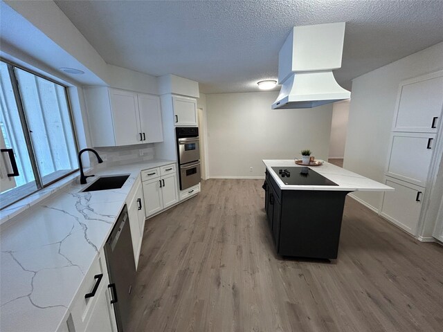 kitchen featuring a center island, white cabinets, sink, tasteful backsplash, and stainless steel appliances