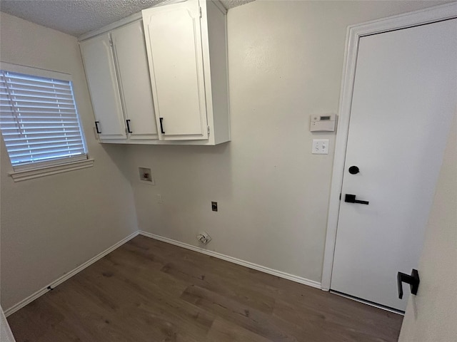 washroom featuring cabinets, hookup for a washing machine, a textured ceiling, and dark wood-type flooring