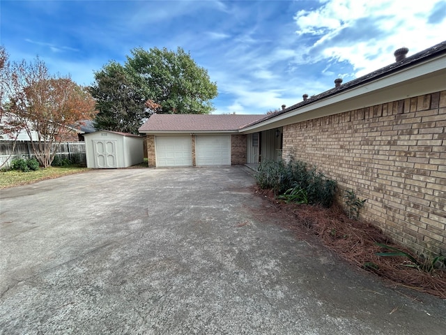 view of property exterior featuring a garage and a storage shed