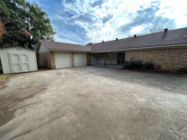 ranch-style home with a garage and a storage unit