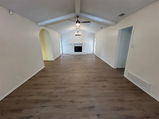 unfurnished living room featuring vaulted ceiling with beams, dark hardwood / wood-style floors, ceiling fan, and a brick fireplace