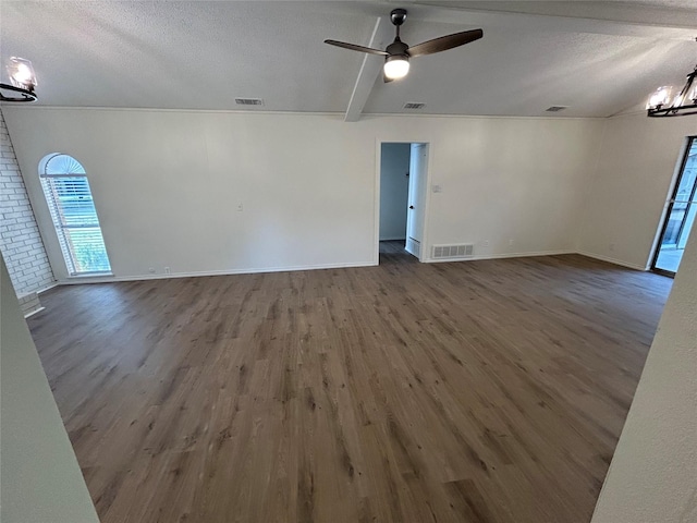 unfurnished room featuring wood-type flooring, beam ceiling, ceiling fan with notable chandelier, and a textured ceiling