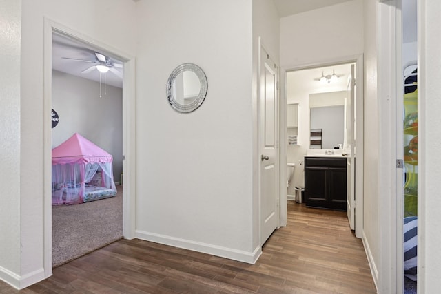 corridor featuring dark hardwood / wood-style flooring and sink