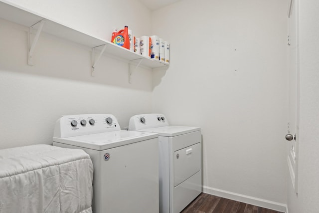 washroom with dark hardwood / wood-style floors and washing machine and clothes dryer