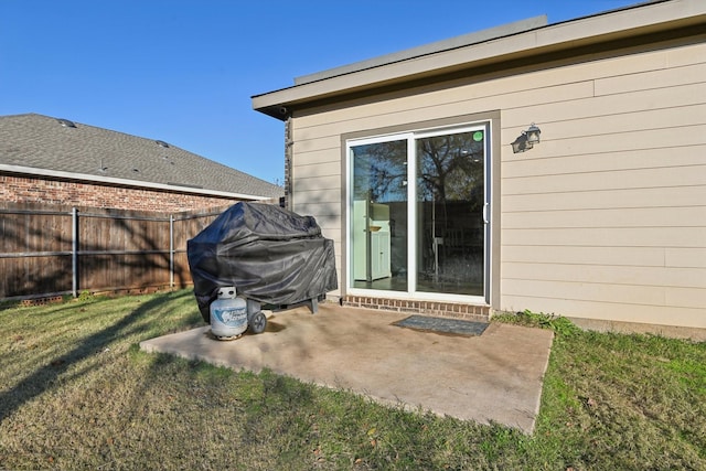 property entrance featuring a patio area and a lawn