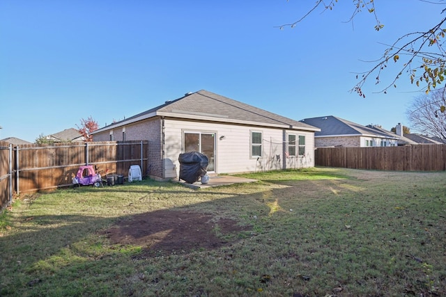 back of house featuring a yard