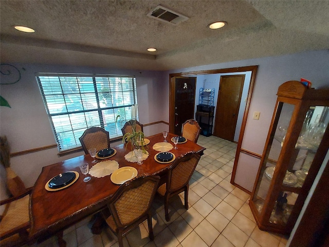 dining room featuring light tile patterned floors and a textured ceiling