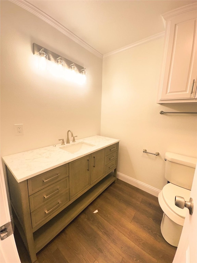 bathroom with hardwood / wood-style floors, toilet, vanity, and ornamental molding