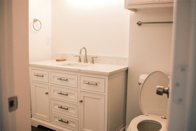 bathroom featuring toilet and vanity