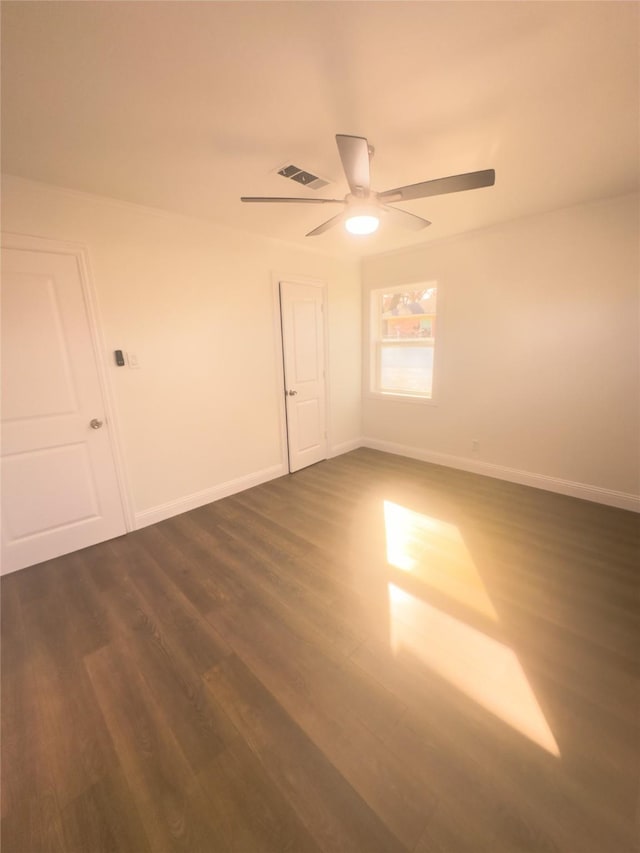 unfurnished room featuring ceiling fan and dark hardwood / wood-style flooring