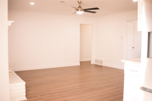 unfurnished room with hardwood / wood-style floors, ceiling fan, and ornamental molding