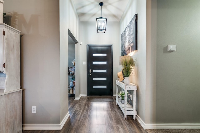 foyer featuring a notable chandelier and dark hardwood / wood-style floors