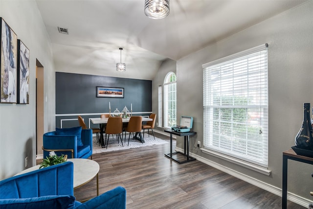 dining space featuring an inviting chandelier, dark hardwood / wood-style flooring, and vaulted ceiling