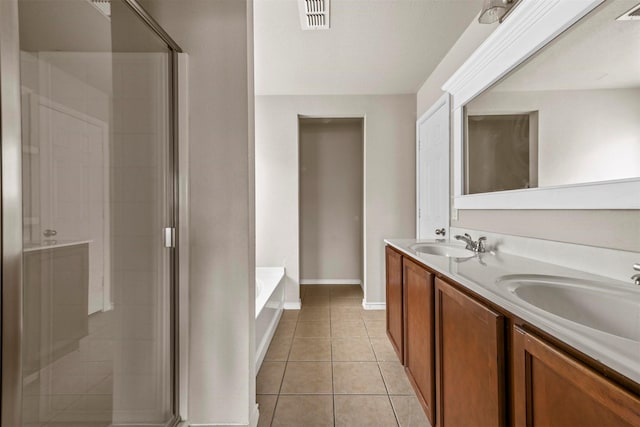 bathroom featuring vanity, shower with separate bathtub, and tile patterned flooring