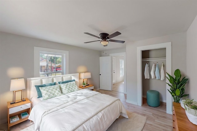 bedroom featuring light hardwood / wood-style floors, a closet, and ceiling fan