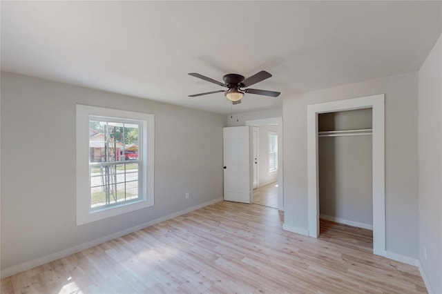 unfurnished bedroom with ceiling fan, a closet, and light hardwood / wood-style floors