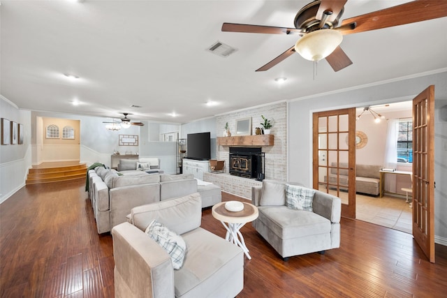 living room with wood-type flooring and crown molding