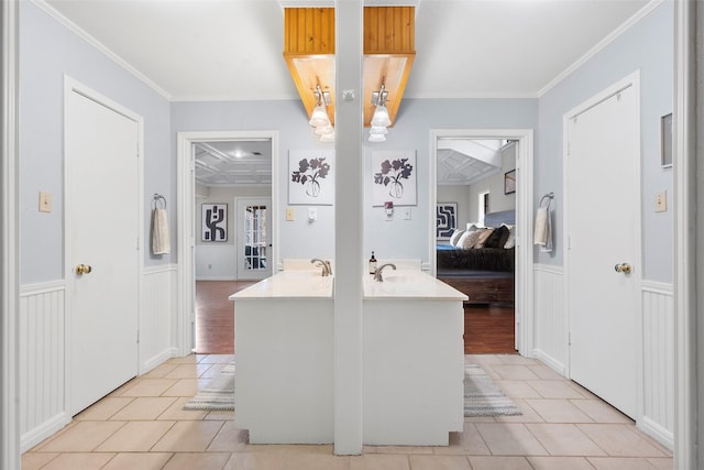 kitchen with ornamental molding, a breakfast bar, and light tile patterned flooring