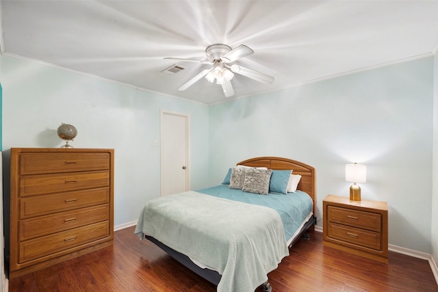 bedroom featuring dark wood-type flooring, ornamental molding, and ceiling fan