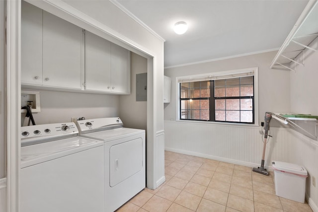 washroom featuring light tile patterned flooring, washing machine and clothes dryer, cabinets, ornamental molding, and electric panel