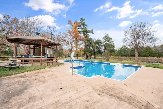 view of pool with a gazebo, a water slide, and a patio area