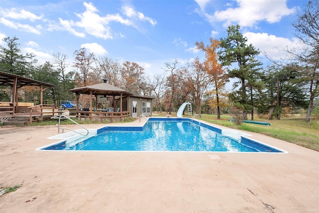 view of swimming pool with a gazebo, a patio area, and a water slide