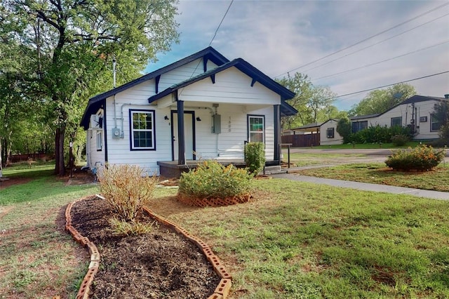 bungalow with a front lawn and a porch